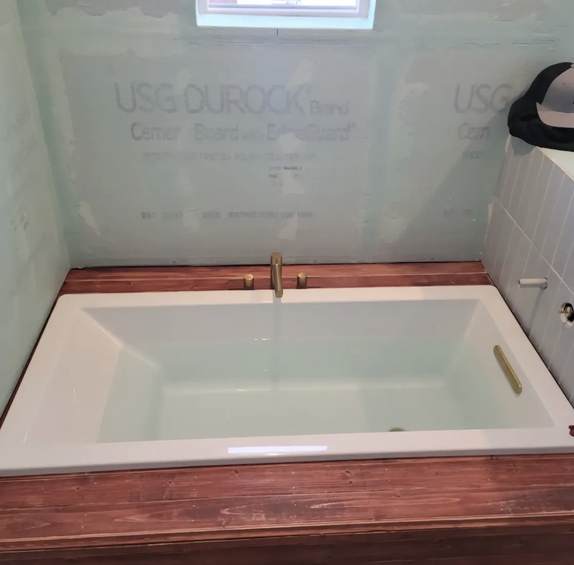 Soaking tub install with brass fixtures